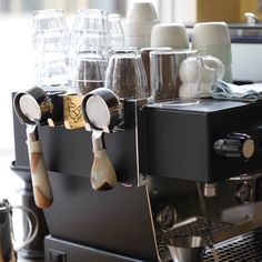 an espresso machine with several cups on it