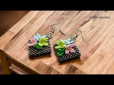 the earrings are decorated with beads and flowers