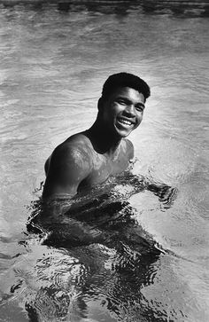 a man swimming in a pool with no shirt on