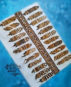 an image of hendi tattoos on the back of a white sheet with gold designs