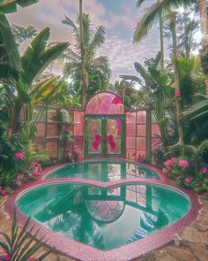 a pool surrounded by palm trees and flowers