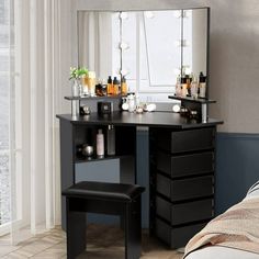 a bedroom with a vanity and stool in it