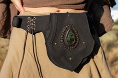 ♥ HANDMADE LEATHER WAIST GEMSTONE LABRADORITE A leather hip bag with a gemstone can be a stylish and functional accessory that adds some flair to any outfit. Depending on the gemstone, it can also add a touch of mystique and spiritual energy to your ensemble. You can wear a leather hip bag with a gemstone around your waist or slung over your shoulder for a bohemian or edgy look. It can be paired with jeans and a t-shirt, a flowing skirt and sandals, or even a maxi dress for a festival or concert Steampunk Belt, Viking Belt, Leather Hip Bag, Hippie Bags, Leather Belt Bag, Flowing Skirt, Protection Stones, Functional Accessories, Edgy Look