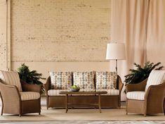 a living room filled with furniture next to a brick wall