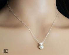 White Pearl Drop Cubic Zirconia Dainty Wedding Bridal Pendant Necklace with .925 Sterling Silver Chain. PLEASE READ ITEM DESCRIPTION before placing your order, and contact me with any questions! CHAIN is 18 inches (45.7cm) long. PENDANT is about 0.47 inch (1.2cm) long including cz bail. BRIDAL NECKLACES SECTION: https://www.etsy.com/shop/LanaChayka?ref=seller-platform-mcnav§ion_id=11638944 JEWELRY SETS SECTION: https://www.etsy.com/shop/LanaChayka?ref=seller-platform-mcnav§ion_id=18873488 BRIDAL JEWELRY SETS SECTION: https://www.etsy.com/shop/LanaChayka?ref=seller-platform-mcnav§ion_id=25839214 Elegant and timeless, this dainty necklace is perfect for weddings or special occasions such as birthdays, anniversaries, graduations, proms...or whatever you can imagine! Handmade necklace, is made Pearl White Bridal Necklace With Pearl Pendant, Delicate Pearl White Bridal Necklace With Pearl Pendant, Pear-shaped White Gold Pearl Wedding Necklace, Dainty Bridal Necklace With Pearl Pendant In Pearl White, Formal Drop-shaped White Gold Pearl Necklace, Bridal Pendant Necklace, Pearl Drop Pendant, Bridal Pendant, Single Pearl Necklace