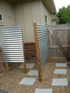 an outdoor area with gravel and wooden posts