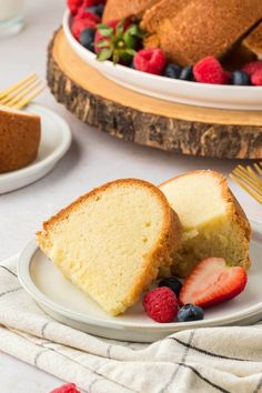 a slice of pound cake on a plate with berries