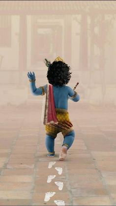 a little boy dressed in blue and yellow is walking down the street with his hands up