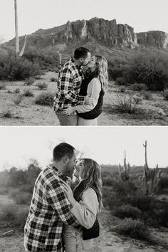 a man and woman kissing in the desert with mountains in the background, black and white photo