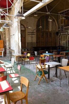 tables and chairs are lined up in an old building