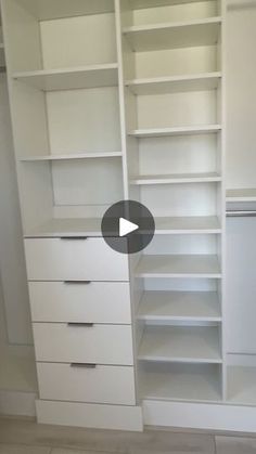 a walk in closet with white shelves and drawers