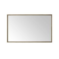 a mirror that is on the wall with a white back ground and light brown frame