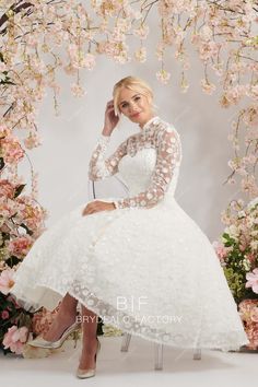 a woman in a white dress is sitting on a chair and posing for the camera