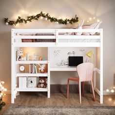 a white bunk bed with a desk and chair in front of it, surrounded by christmas lights