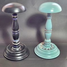 two blue and silver candlesticks sitting next to each other