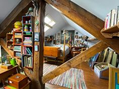 an attic bedroom with bookshelves full of books