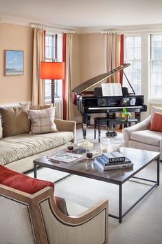 a living room filled with furniture and a piano