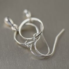 These earrings feature a 12mm Off center ring with a dangling, cast sterling silver teardrop. They earrings are on light weight sterling silver wires and measure 1 1/4 inches in length. Total length: 1 1/4 inches Materials: Sterling Silver Matching jewelry https://www.etsy.com/shop/southpawstudios/search?search_query=minimalist Regular earwire (A.) or Leverbacks (B.) options available. Good info to know: ♦ Ordering FAQ's http://www.etsy.com/shop/southpawstudios/policy ♦ Questions? Feel free to s Earrings Teardrop, Mixed Metal Jewelry, Sterling Silver Chain Necklace, Matching Jewelry, Unisex Jewelry, 925 Sterling Silver Chain, Silver Gifts, Silver Chain Necklace, Earrings Dangle