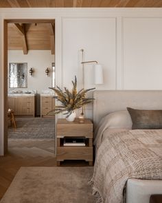 a bed sitting in a bedroom next to a wooden ceiling