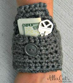 a person's arm with a crocheted wristband and a button on it