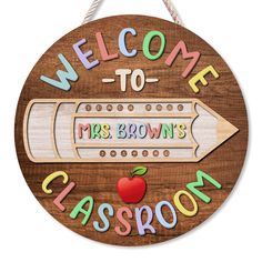 a wooden sign with the words welcome to mrs brown's classroom and an apple