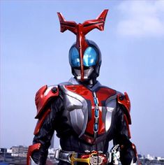 a man in a red and silver suit standing on top of a roof