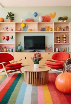 a living room with colorful striped carpet and wooden shelves on the wall, two orange chairs in front of a television