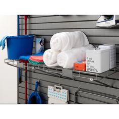 there are towels and other items on the shelf in this garage storage area that is organized