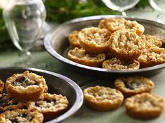 several small pies in metal pans on a table