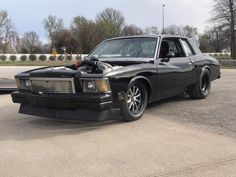 a black car parked in a parking lot