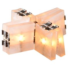 three pieces of clear plastic with lights attached to them on a white background, set against each other