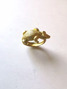 Crocodile Ring. Animal handmade ring. Brass, copper jewelry. Adjustable ring. Unisex ring, gift for woman, man. Zoo ring. Handmade ring made of real brass. The crocodile-shaped ring is adjustable. The crocodile symbolizes strength, endurance, and is a symbol of honor. DELIVERY Processing time is 1 -3 business days after ordering. I use Registered Delivery to send my items. You will receive the TRACKING number after the item is shipped. If you have any questions regarding this item, please do not Gold Brass Snake Ring For Gift, Crocodile Jewelry, Crocodile Accessories, Gift For Woman, Unisex Ring, Handmade Rings, Adjustable Ring, Copper Jewelry, Ring Handmade