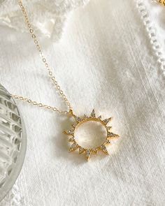 First the moon, then the sun. Add the Sun Necklace to your collection today. Cubic zirconia sun Charm size: 19.5x22.5mm 14kt Gold plated brass pendant & gold filled chain All items come in a gift box ready to gift. To see more please visit my Etsy shop at https://www.etsy.com/shop/BijouLimon Bijou Limon jewelry collections present a romantic French spin on the latest jewelry trends. Based on the US West Coast but French at heart, Bijou Limon interprets the current jewelry trends and delivers tim Sun And Moon Design Necklace For Gift, Sun And Moon Design Necklace As Gift, Gift Moon And Sun Design Necklaces, Round Adjustable Necklace With Sun And Moon Design, Adjustable Round Sun And Moon Design Necklace, Cubic Zirconia Moon Charm Necklace With Round Pendant, Cubic Zirconia Moon Charm Necklace, Cubic Zirconia Pendant Necklace With Moon Charm, Celestial Cubic Zirconia Pendant Necklace