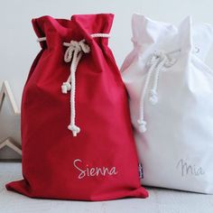 two drawstring bags sitting next to each other