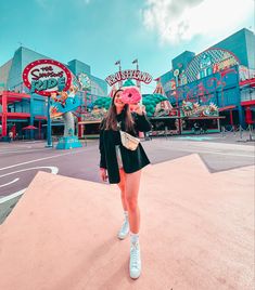 a woman standing in front of a carnival