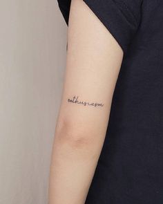 a person with a tattoo on their arm that says, mother's day written in cursive font