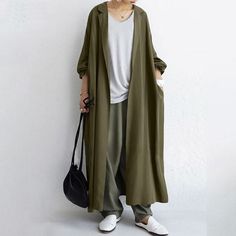 Looking for the perfect transitional piece? Look no further than our Maxi Open Front Duster Cardigan. Not only does this coat offer coverage for chillier nights, but it also features long sleeves and a notched lapel that will make you feel polished without feeling overdone. The beautiful maxi cut design adds a touch of sophistication, making you ready to take on anything! Whether you’re spending a day in the office or heading out to brunch, this coat has got you covered. Outer Long, Outer Style, Fashion Slogans, Long Outer, Long Outfit, Kurta Patterns, Iranian Women Fashion, Iranian Women, Long Trench