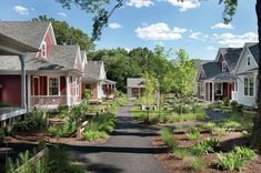 a row of houses with red shutters and trees