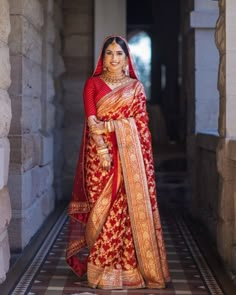 a woman in a red and gold sari