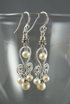 Elegant white pearl chandelier earrings are reminiscent of a tulip bud - inverted as they often are! These floral style earrings would make perfect wedding jewelry. An original and timeless earring design Earring Length: approx. 1.25 inches (not including ear hooks) Earhooks: 925 Sterling Silver Handmade White Chandelier Earrings For Anniversary, Elegant White Chandelier Earrings, White Wire Wrapped Pearl Earrings For Wedding, Elegant Wire Wrapped Chandelier Earrings For Wedding, Elegant Wire Wrapped Chandelier Earrings, Wire Wrapped Drop Chandelier Earrings For Weddings, Wire Wrapped Dangle Chandelier Earrings For Wedding, Classic White Sterling Silver Chandelier Earrings, Chandelier Earrings Wedding