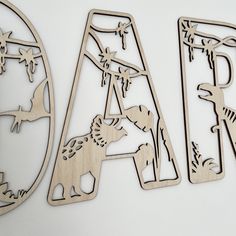 three wooden cutout letters with animals on them and the letter a in the middle