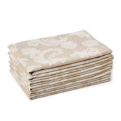 four folded towels stacked on top of each other in beige and white paisley print fabric