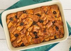 a casserole dish filled with bread and olives