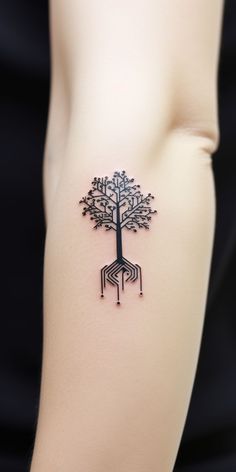 a woman's arm with a tree tattoo on the left side of her body