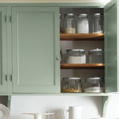 the cabinets in the kitchen are painted green