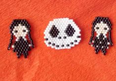 three different types of bead designs on an orange surface, one with a skull and the other with a skeleton