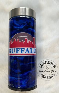 a blue can with the word buffalo on it is sitting on a white fur surface