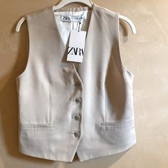 Zara Light Tan Vest / Waistcoat - Size S - A Relaxed Feel On New With Tags Sleeveless Vest/Top Is Lined And Has Buttons Up The Front. 2 (False) Front Pockets And A Back Vent. Approx. Measurements Laid Flat: Underarm To Underarm: 17.5” Length Center Back To Hem: 18.5” Exterior 62% Viscose 38% Lyocell Lining 100% Viscose Excellent Condition, Never Worn. Item Bought In Switzerland. Cover Photo Is A Stock Photo Not Item For Sale. Beige Button-up Vest For Work, Tailored Spring Vest Outerwear, Spring Button-up Vest Outerwear, Zara Beige Vest For Fall, Spring Office Vest Single Breasted, Spring Single-breasted Office Vest, Zara Fitted Vest For Workwear, Zara Fitted Spring Vest, Beige Single Breasted Vest For Spring