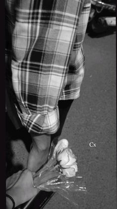 a black and white photo of someone holding something in their hand