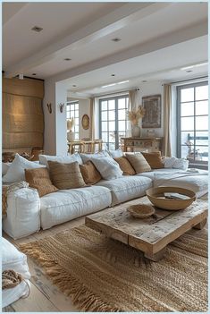 a living room filled with lots of furniture and pillows on top of a wooden table